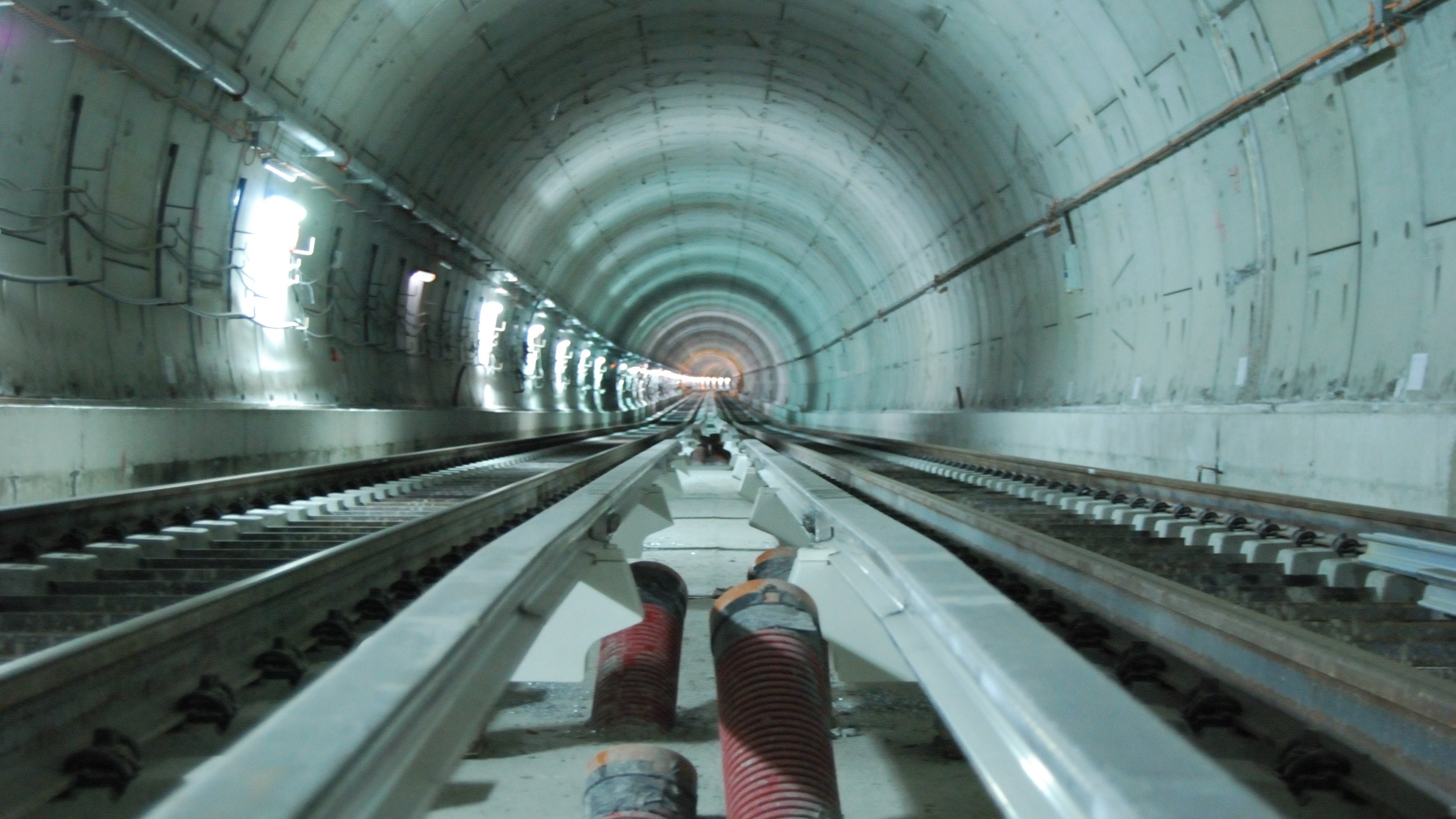 Tunnel with train tracks and concrete walls