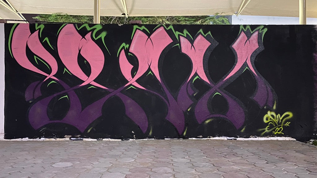 Spam graffiti art on a black background with pink and purple designs.
